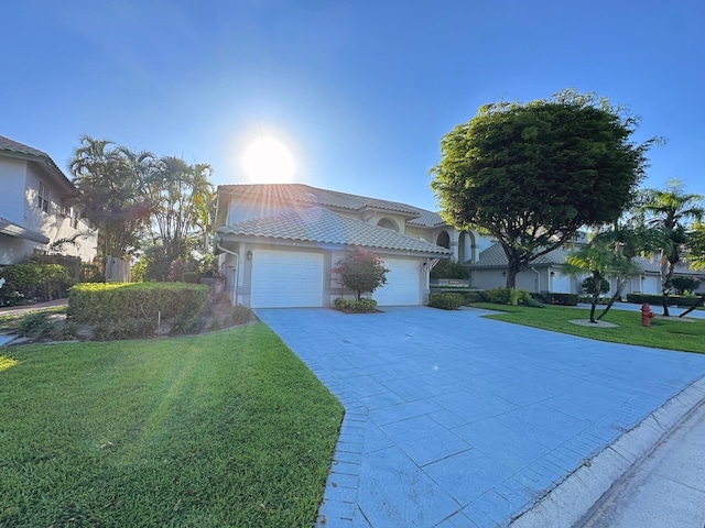 11666 Briarwood Cir Unit 1, Boynton Beach, FL 33437 - mediterranean / spanish house with a garage, a front lawn, driveway, a tiled roof, and stucco siding