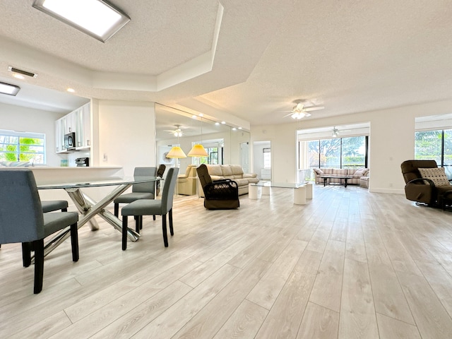 11666 Briarwood Cir Unit 1, Boynton Beach, FL 33437 - dining space featuring a textured ceiling, a ceiling fan, and light wood-type flooring