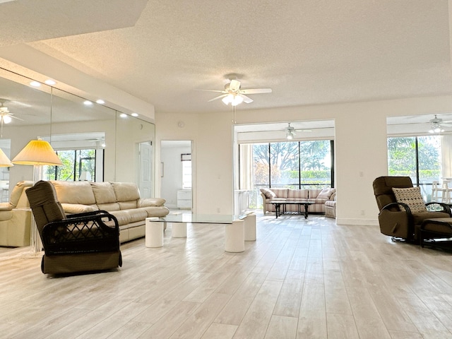 11666 Briarwood Cir Unit 1, Boynton Beach, FL 33437 - living area with ceiling fan, light wood-style floors, a textured ceiling, baseboards, and recessed lighting