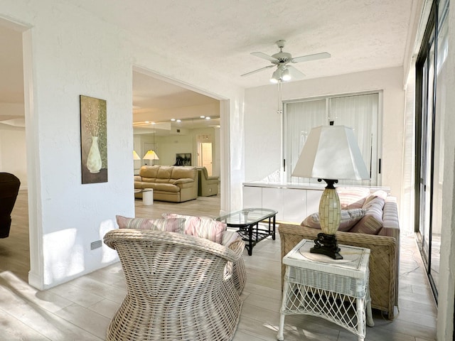 11666 Briarwood Cir Unit 1, Boynton Beach, FL 33437 - living area featuring ceiling fan, wood finished floors, and a textured ceiling