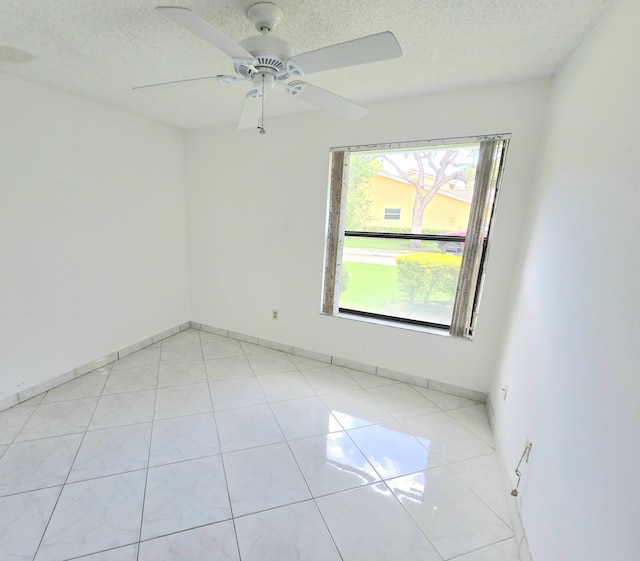 20975 Del Casa Dr, Boca Raton, FL 33433 - spare room featuring a textured ceiling, ceiling fan, and baseboards