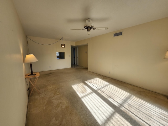 unfurnished living room featuring carpet floors and a ceiling fan