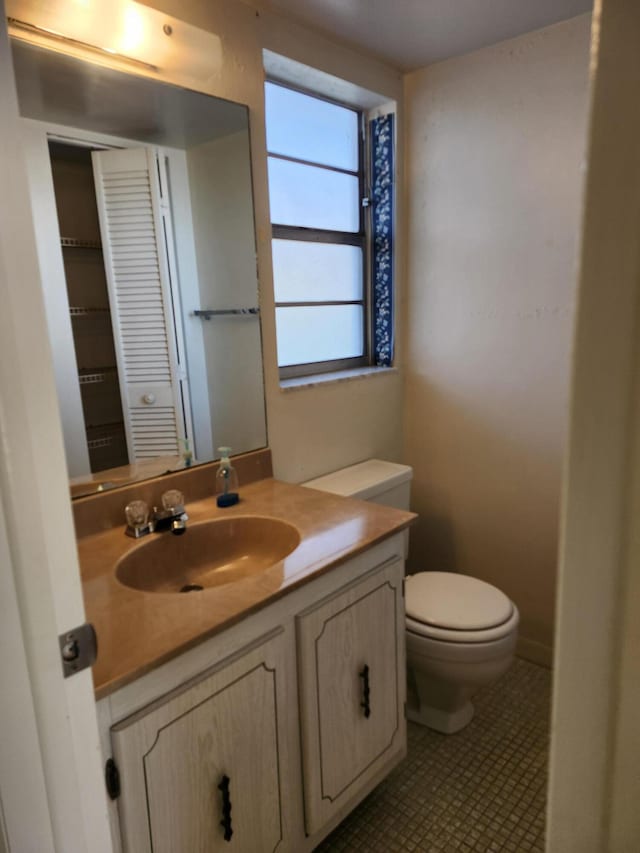 half bath featuring toilet and vanity