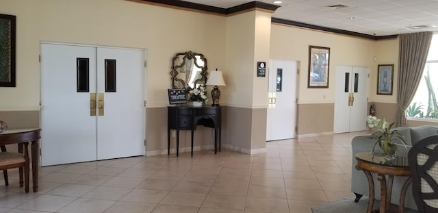 tiled living room with ornamental molding and baseboards