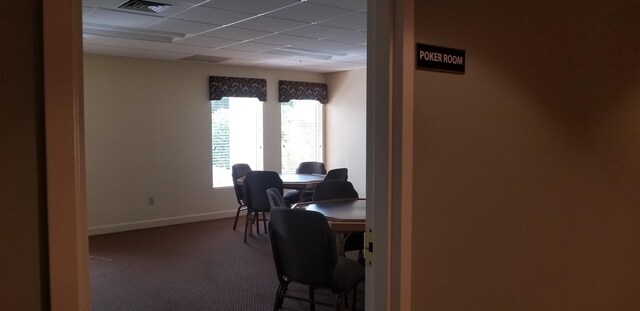 home office with carpet flooring, baseboards, and a drop ceiling