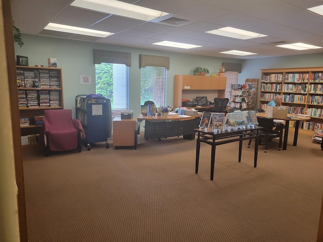 carpeted office featuring a paneled ceiling