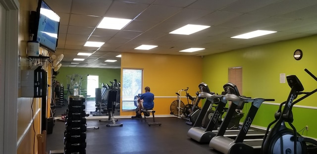 workout area with baseboards and a drop ceiling