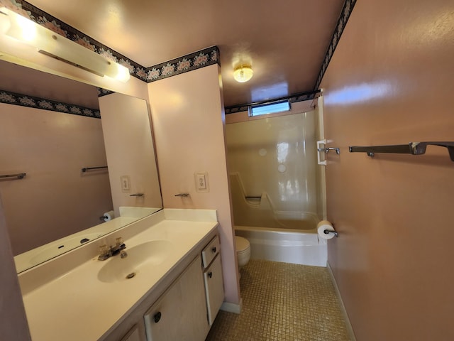 bathroom with toilet, baseboards, vanity, tile patterned flooring, and shower / washtub combination