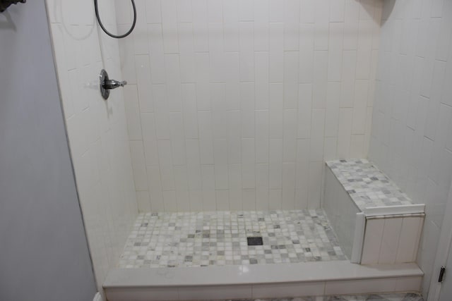bathroom with a tile shower