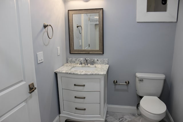 12015 Colony Ave, Palm Beach Gardens, FL 33410 - half bathroom with marble look tiles, vanity, baseboards, and toilet
