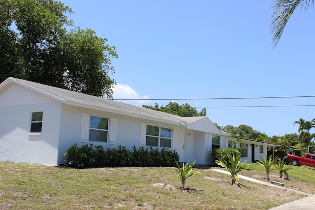12015 Colony Ave, Palm Beach Gardens, FL 33410 - ranch-style house featuring a front yard and stucco siding