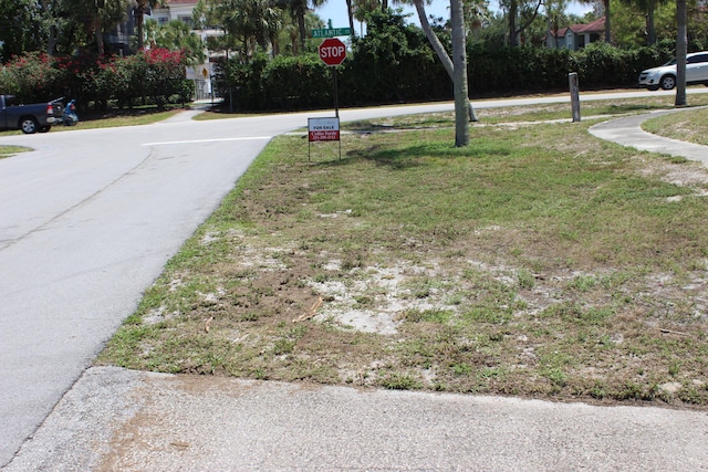 12015 Colony Ave, Palm Beach Gardens, FL 33410 - view of asphalt road with traffic signs