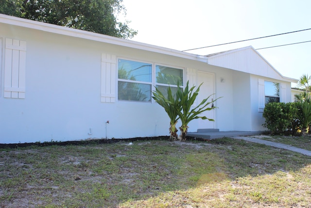 view of side of property featuring stucco siding