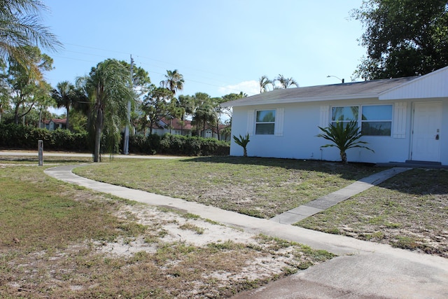 view of side of home with a lawn