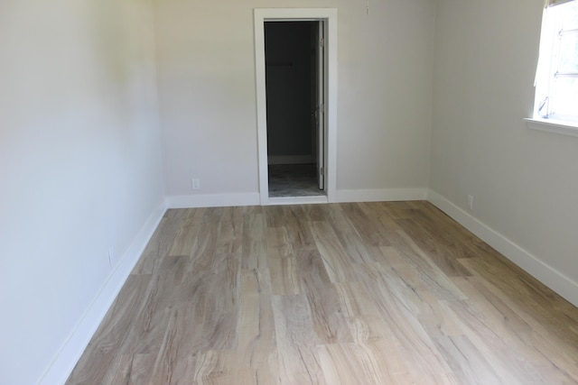 unfurnished room with wood finished floors and baseboards