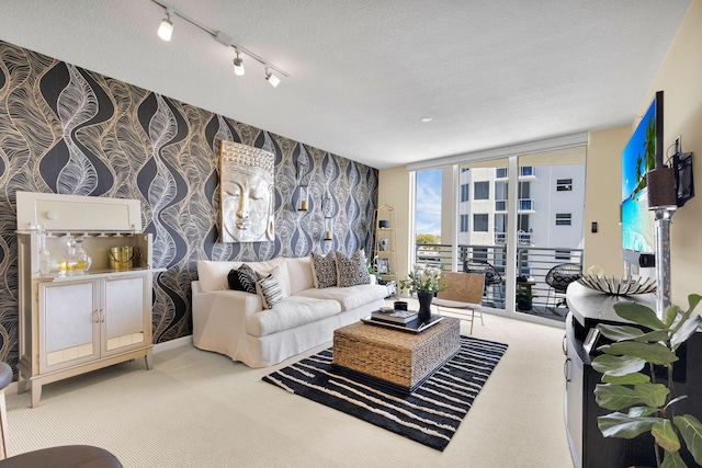1551 N Flagler Dr Unit 804, West Palm Beach, FL 33401 - living room featuring carpet, expansive windows, wallpapered walls, and a textured ceiling