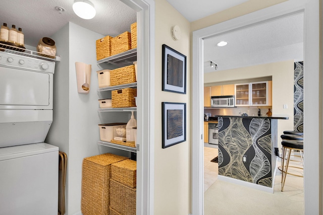 1551 N Flagler Dr Unit 804, West Palm Beach, FL 33401 - clothes washing area featuring stacked washer / dryer