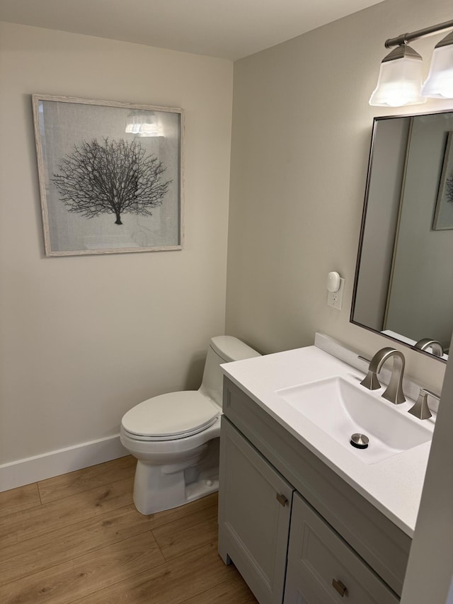 3400 Spanish Wells Dr Unit 52-C, Delray Beach, FL 33445 - bathroom with toilet, vanity, wood finished floors, and baseboards