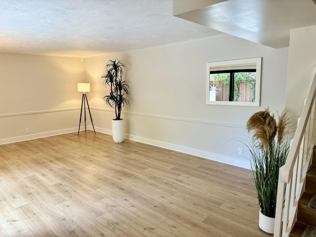 3400 Spanish Wells Dr Unit 52-C, Delray Beach, FL 33445 - empty room with light wood-style flooring, a textured ceiling, and baseboards