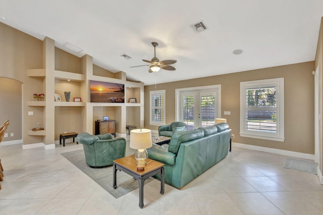 3020 SE St Lucie Blvd, Stuart, FL 34997 - living area with built in features, ceiling fan, baseboards, vaulted ceiling, and light tile patterned floors