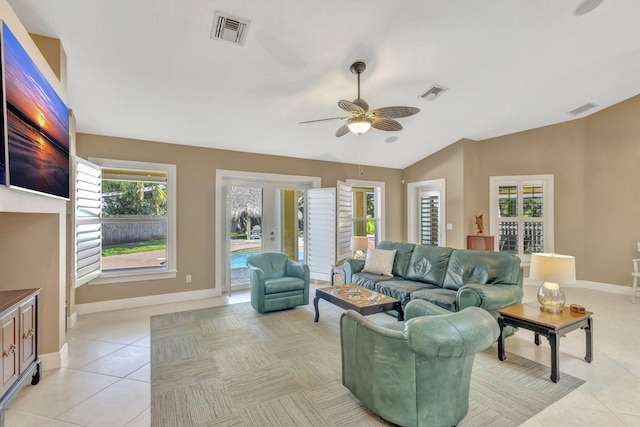 3020 SE St Lucie Blvd, Stuart, FL 34997 - living area with ceiling fan, light tile patterned flooring, baseboards, and vaulted ceiling