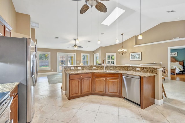 3020 SE St Lucie Blvd, Stuart, FL 34997 - kitchen with a ceiling fan, stainless steel appliances, a sink, lofted ceiling, and brown cabinetry