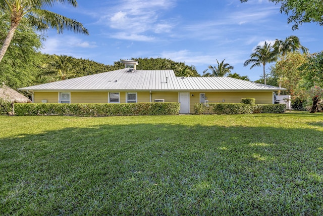 3020 SE St Lucie Blvd, Stuart, FL 34997 - rear view of property with metal roof and a yard