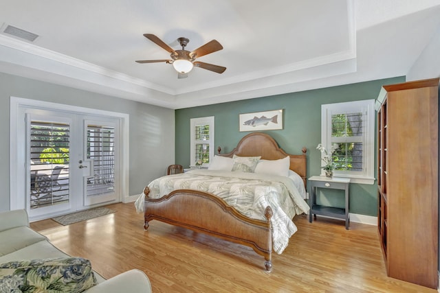 3020 SE St Lucie Blvd, Stuart, FL 34997 - bedroom with a tray ceiling, access to exterior, light wood finished floors, baseboards, and ornamental molding