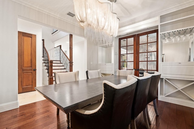 12891 Inshore Dr, Palm Beach Gardens, FL 33410 - dining area featuring hardwood / wood-style flooring, crown molding, a chandelier, stairway, and baseboards