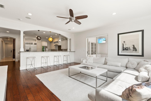 12891 Inshore Dr, Palm Beach Gardens, FL 33410 - living room with arched walkways, ceiling fan, decorative columns, recessed lighting, and dark wood-type flooring