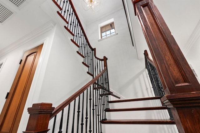 12891 Inshore Dr, Palm Beach Gardens, FL 33410 - stairway with ornamental molding, a high ceiling, and a chandelier