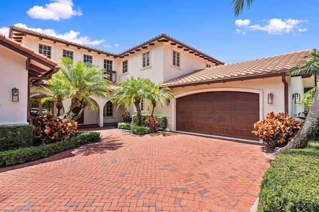 12891 Inshore Dr, Palm Beach Gardens, FL 33410 - mediterranean / spanish-style home featuring decorative driveway, stucco siding, and a tiled roof