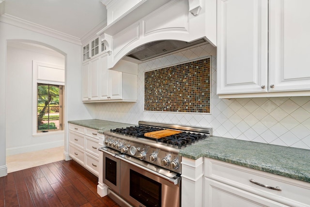 12891 Inshore Dr, Palm Beach Gardens, FL 33410 - kitchen with double oven range, custom range hood, decorative backsplash, white cabinets, and ornamental molding