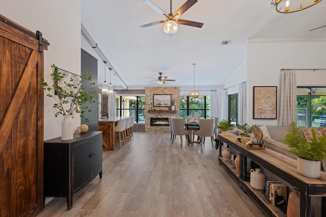 17315 Orange Blvd, Loxahatchee, FL 33470 - interior space featuring ceiling fan, ornamental molding, wood finished floors, a fireplace, and healthy amount of natural light