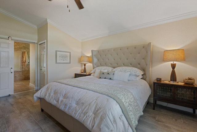 17315 Orange Blvd, Loxahatchee, FL 33470 - bedroom featuring wood finished floors, vaulted ceiling, a barn door, crown molding, and ceiling fan