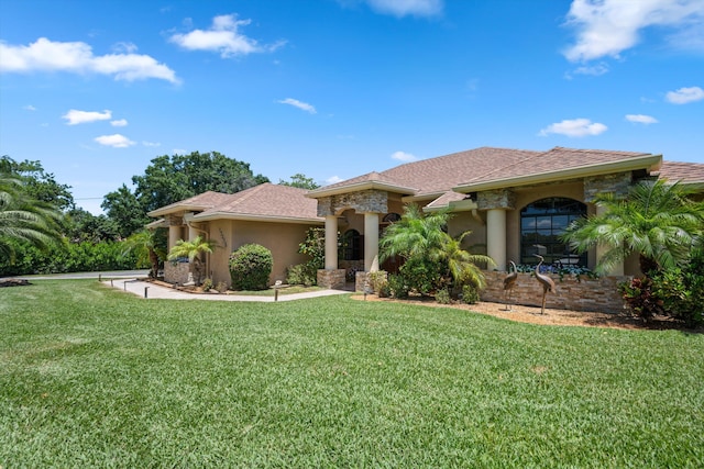 17315 Orange Blvd, Loxahatchee, FL 33470 - mediterranean / spanish-style house featuring a front yard and stucco siding
