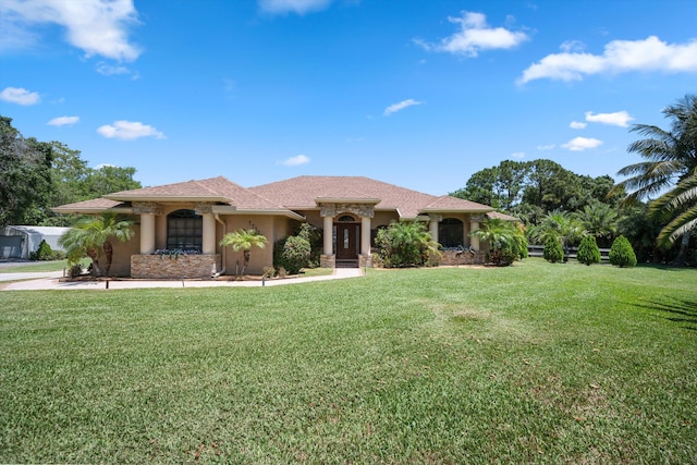 17315 Orange Blvd, Loxahatchee, FL 33470 - view of front facade featuring stucco siding and a front lawn