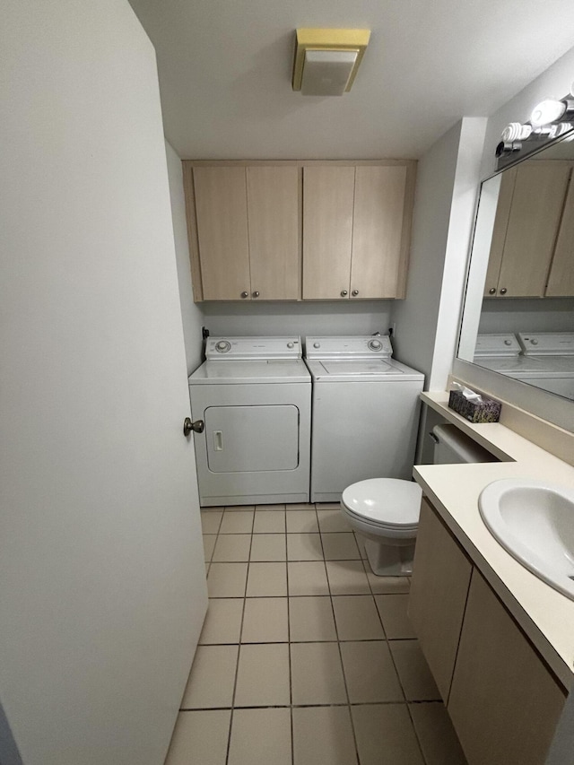 bathroom featuring washing machine and dryer, tile patterned flooring, toilet, and vanity