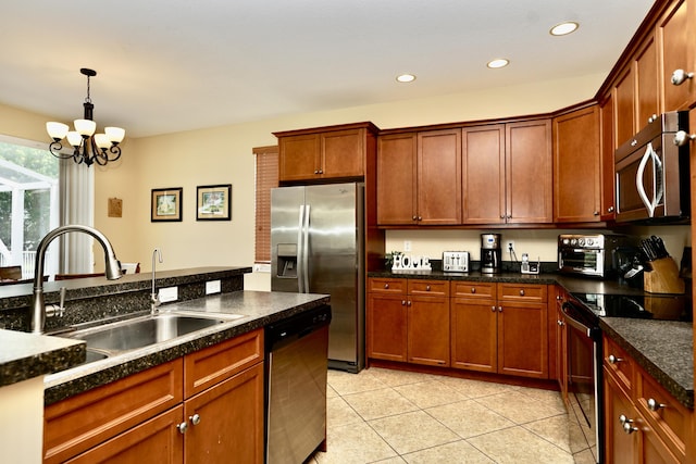 kitchen with appliances with stainless steel finishes, a sink, light tile patterned flooring, a chandelier, and recessed lighting