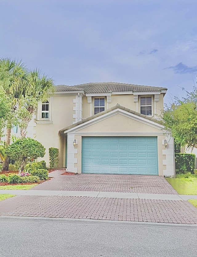 11296 SW Barton Way, Port Saint Lucie, FL 34987 - view of front of house featuring decorative driveway, stucco siding, and a garage