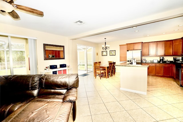 11296 SW Barton Way, Port Saint Lucie, FL 34987 - kitchen with stainless steel refrigerator, open floor plan, a chandelier, light tile patterned floors, and recessed lighting