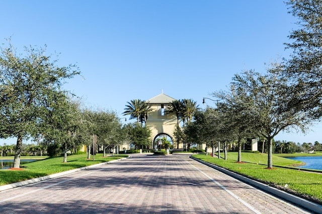 view of community with a lawn and a water view