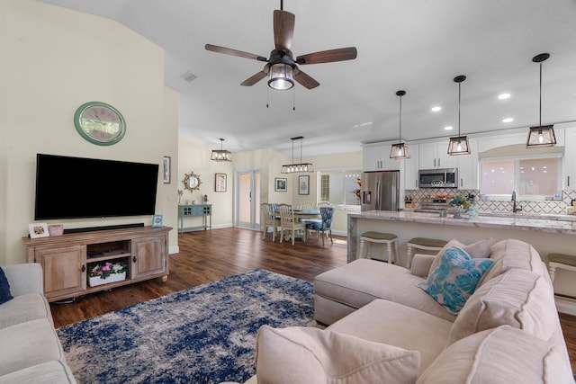 7884 Travlers Tree Dr, Boca Raton, FL 33433 - living room with dark wood-style floors, ceiling fan, recessed lighting, baseboards, and vaulted ceiling