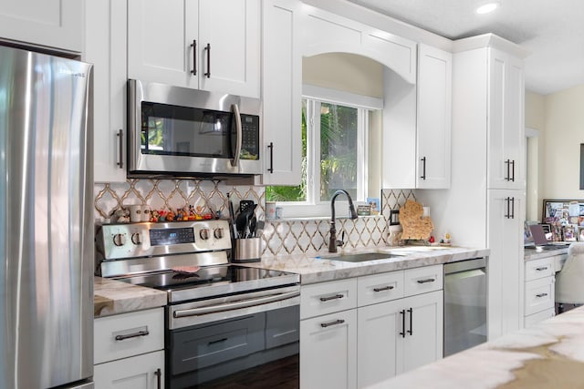 7884 Travlers Tree Dr, Boca Raton, FL 33433 - kitchen with appliances with stainless steel finishes, a sink, backsplash, white cabinets, and recessed lighting
