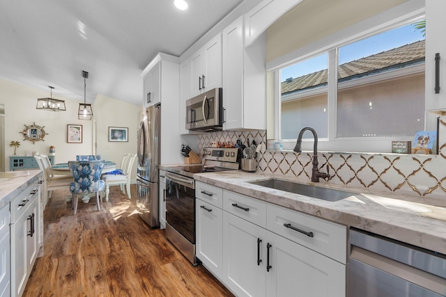 7884 Travlers Tree Dr, Boca Raton, FL 33433 - kitchen featuring stainless steel appliances, a sink, dark wood-type flooring, tasteful backsplash, and white cabinets