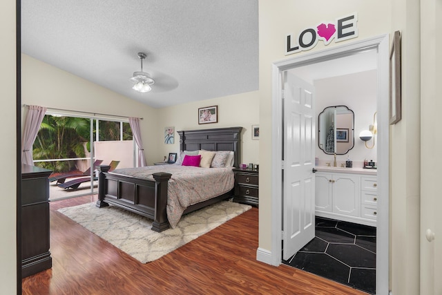 7884 Travlers Tree Dr, Boca Raton, FL 33433 - bedroom with lofted ceiling, ensuite bath, dark wood finished floors, a textured ceiling, and a sink