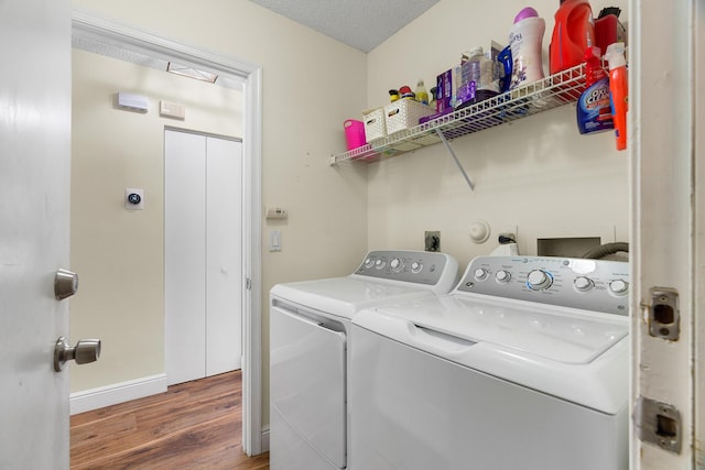 7884 Travlers Tree Dr, Boca Raton, FL 33433 - laundry area featuring washer and dryer, wood finished floors, and baseboards