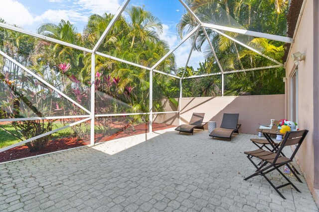 7884 Travlers Tree Dr, Boca Raton, FL 33433 - fenced backyard with a patio area and glass enclosure