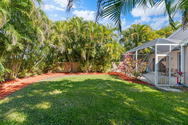 7884 Travlers Tree Dr, Boca Raton, FL 33433 - view of yard with a patio area and glass enclosure