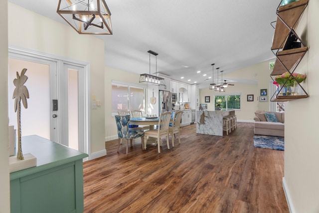 7884 Travlers Tree Dr, Boca Raton, FL 33433 - dining area featuring a chandelier, dark wood-style flooring, baseboards, recessed lighting, and vaulted ceiling